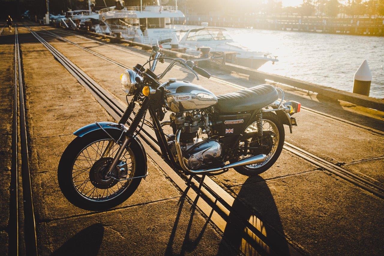 1973 Triumph Bonneville T140V with boats and wharf in background