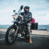 Daniel 'Beardy' McLaughlin on a Royal Enfield Himalayan at Bondi Beach