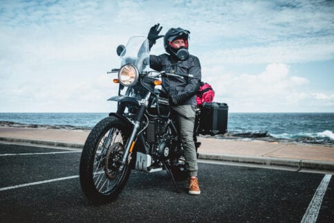 Daniel 'Beardy' McLaughlin on a Royal Enfield Himalayan at Bondi Beach