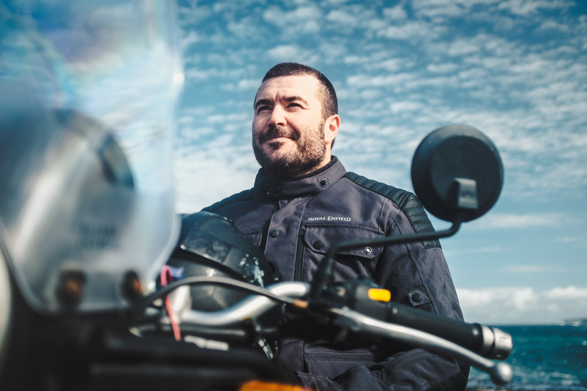 Daniel 'Beardy' McLaughlin on a Royal Enfield Himalayan at Bondi Beach