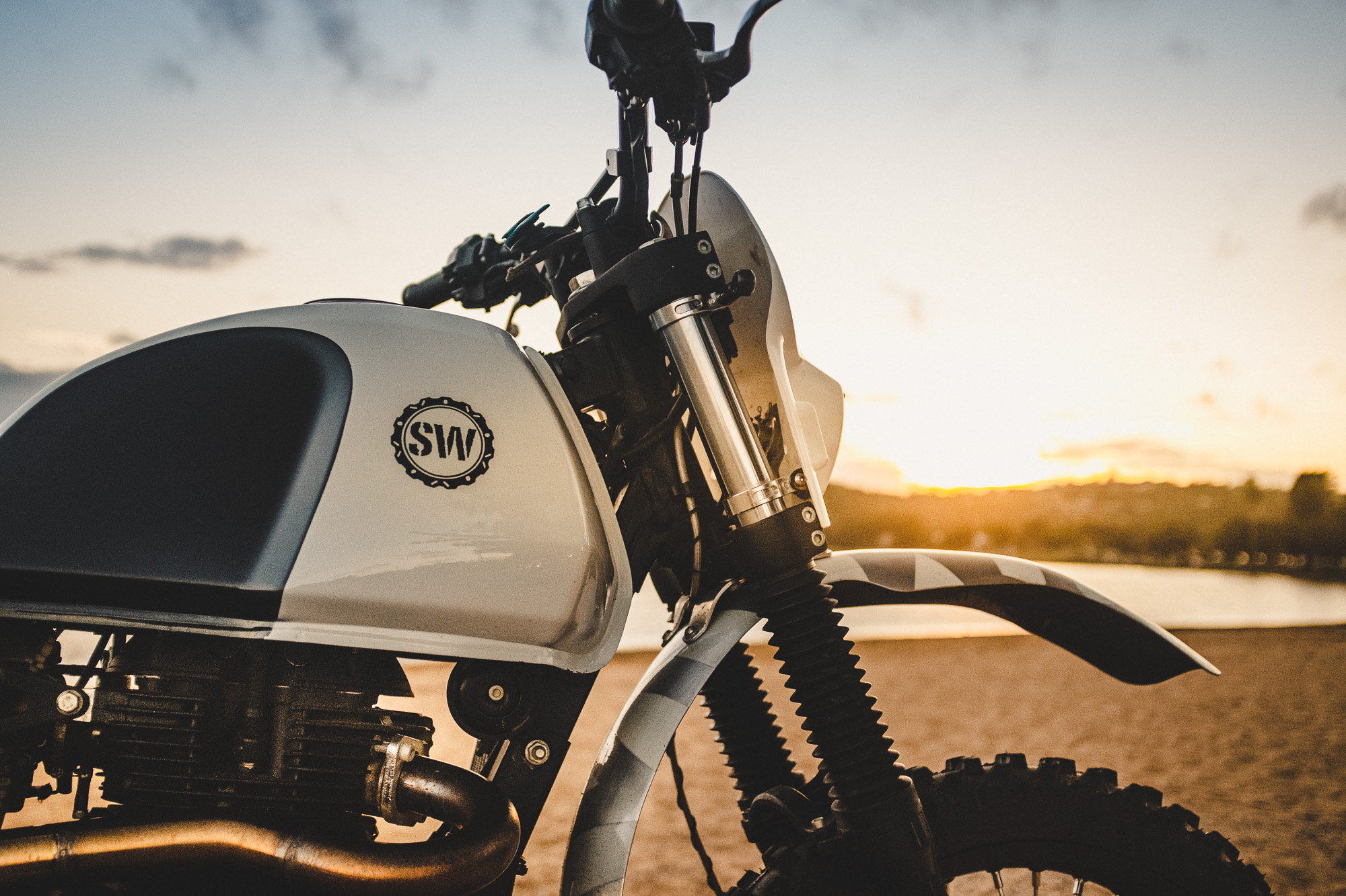 Schlachtwerk's Royal Enfield Himalayan Enduro Custom on a beach at sunset in Sydney