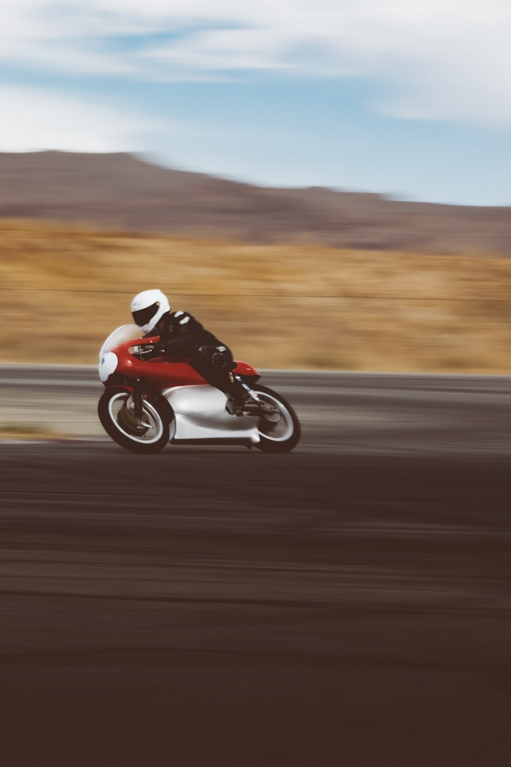 Red motorcycle racing on a track