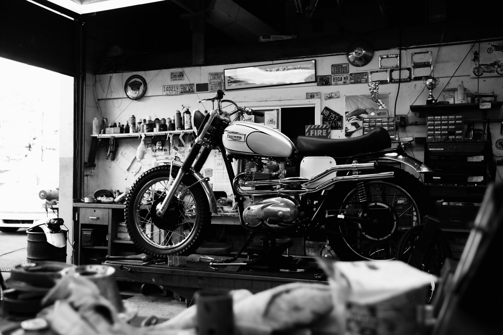 Black and white photo of a Triumph Motorcycle in a workshop