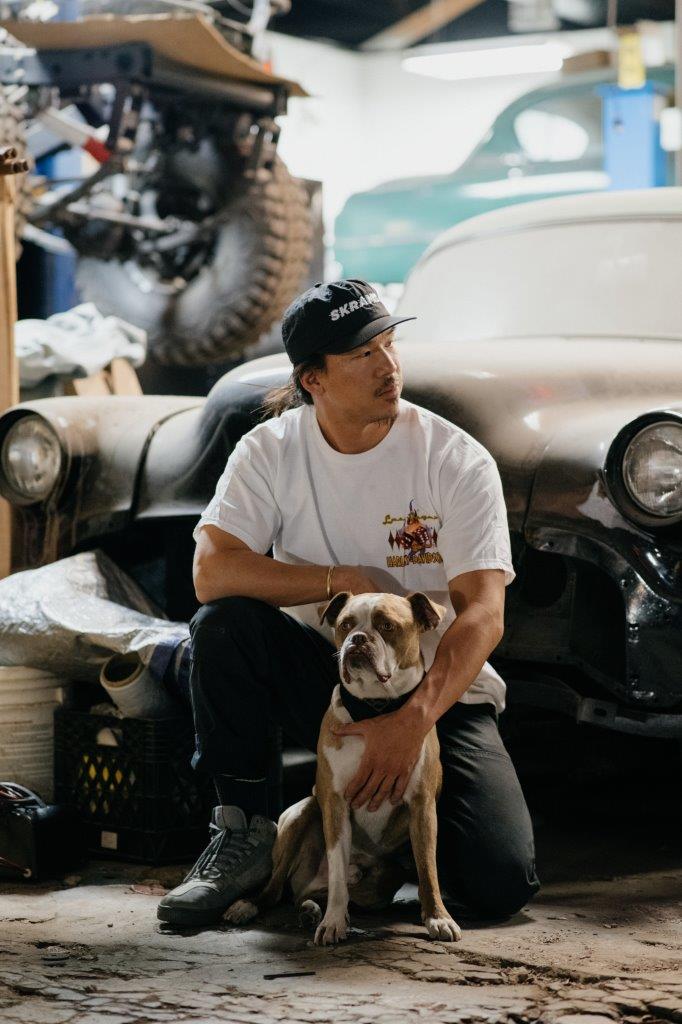 David Chang from Cafe Racers of Instagram in a garage with his dog