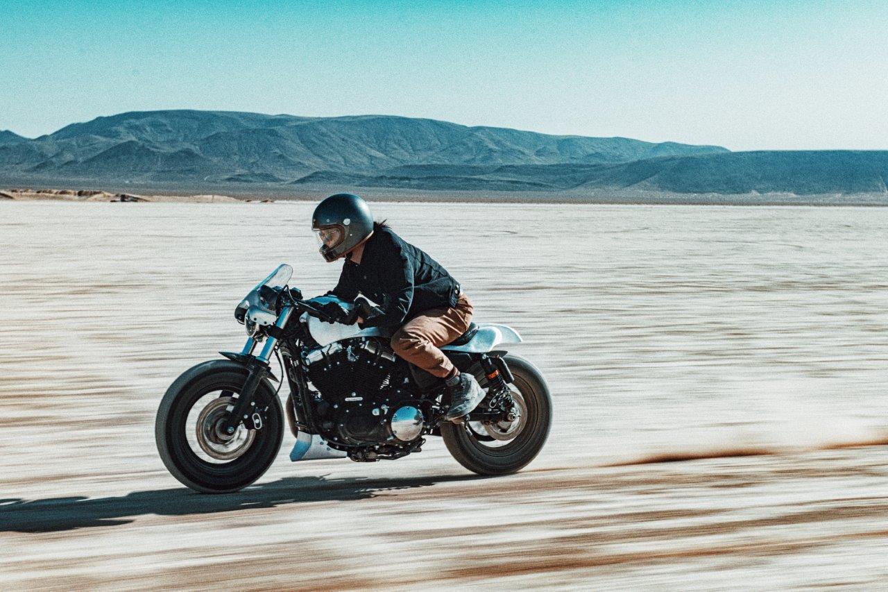 David Chang from Cafe Racers of Instagram on a Harley motorcycle riding on a salt flat