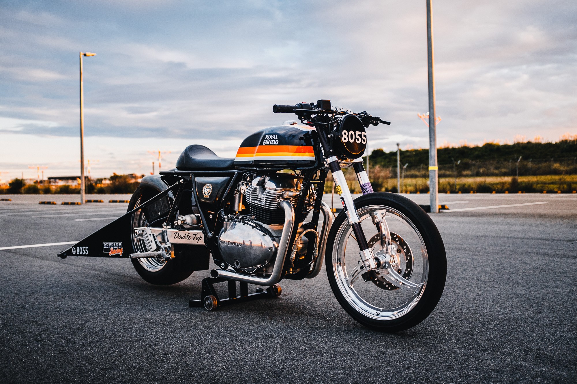 A Royal Enfield 650 Twin drag bike in a Sydney car park at sunset