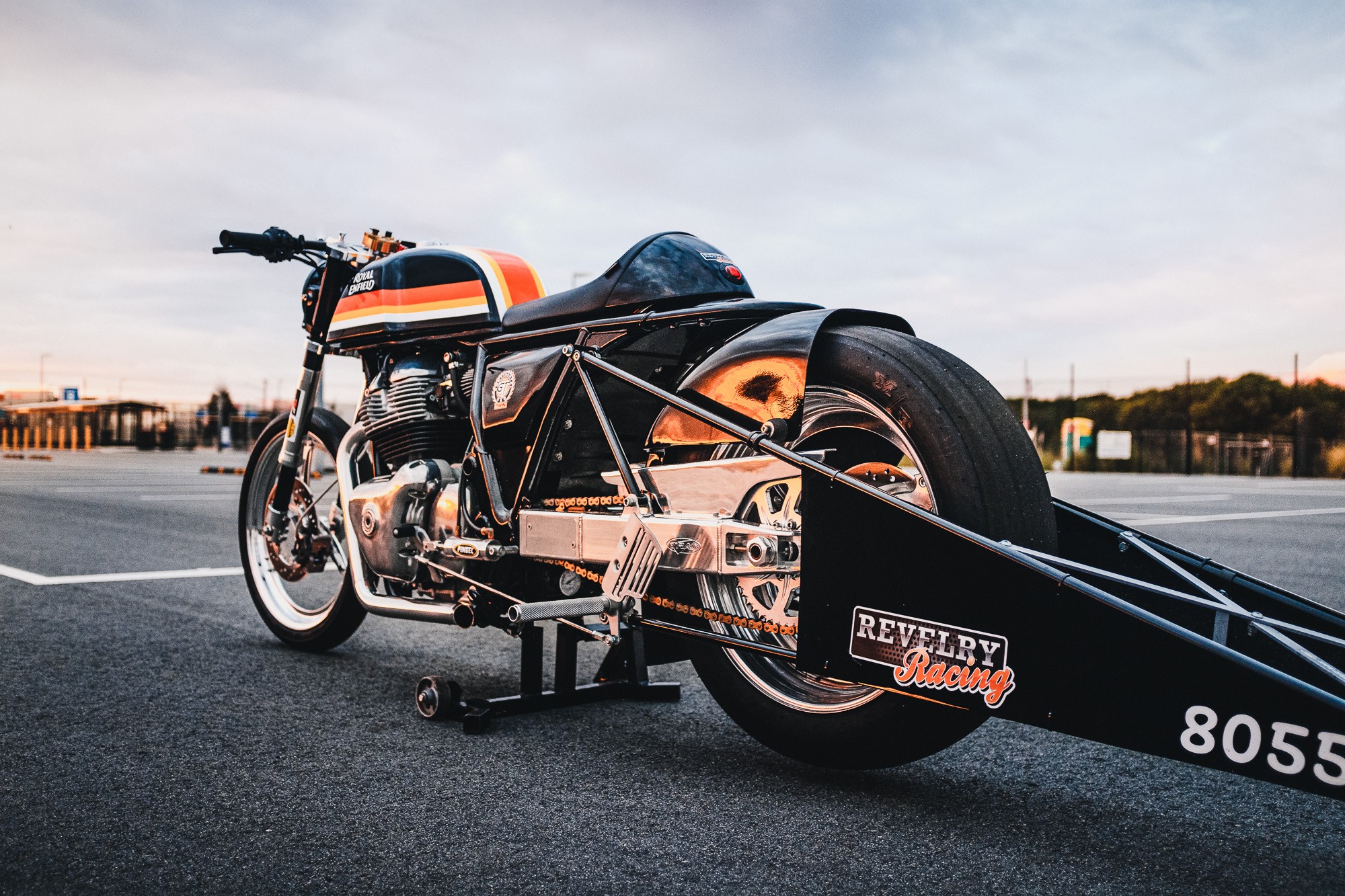 A royal Enfiled 650 Twin drag bike in a Sydney car park at sunset