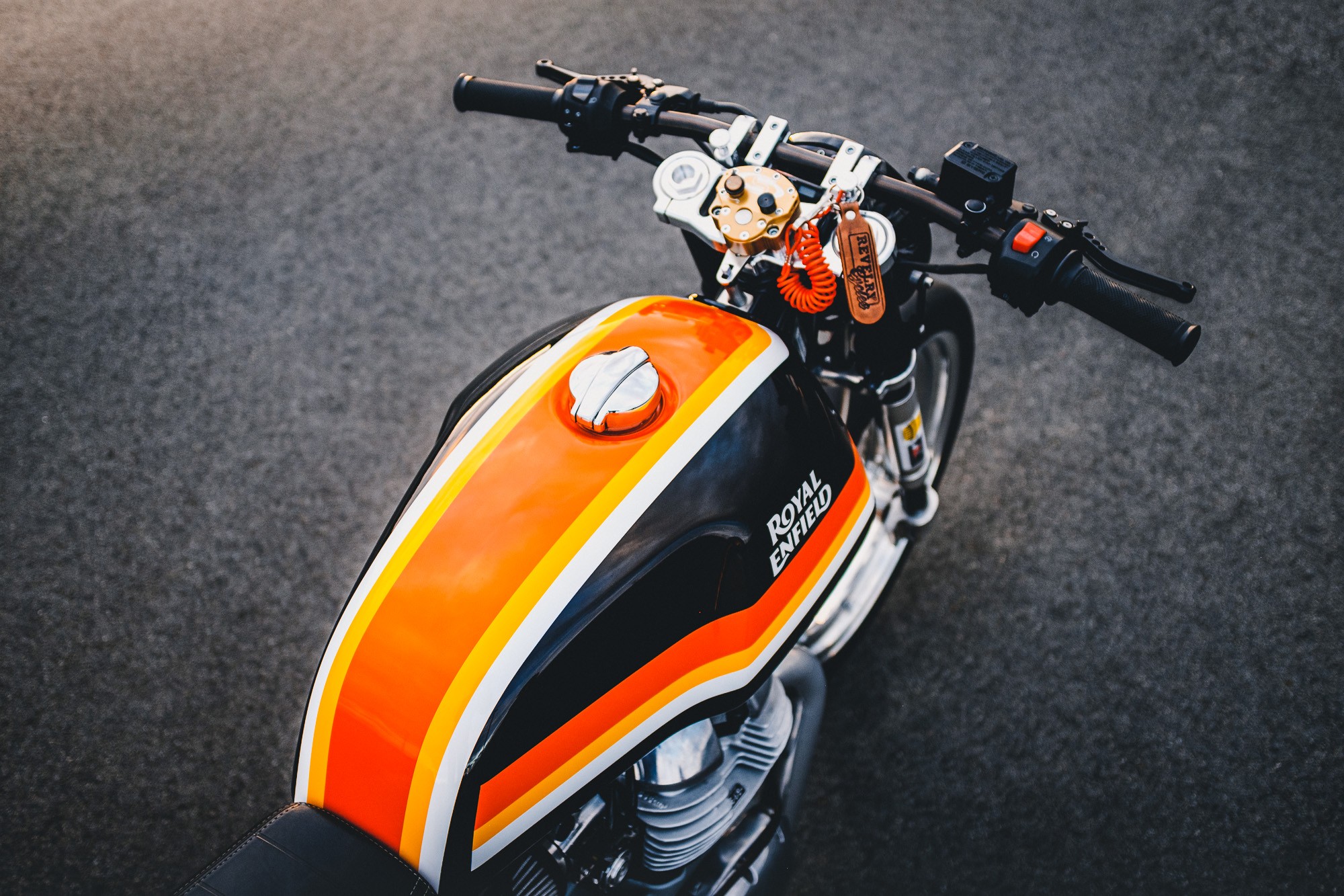 A detail shot of a Royal Enfield 650 Twin drag bike in a Sydney car park at sunset