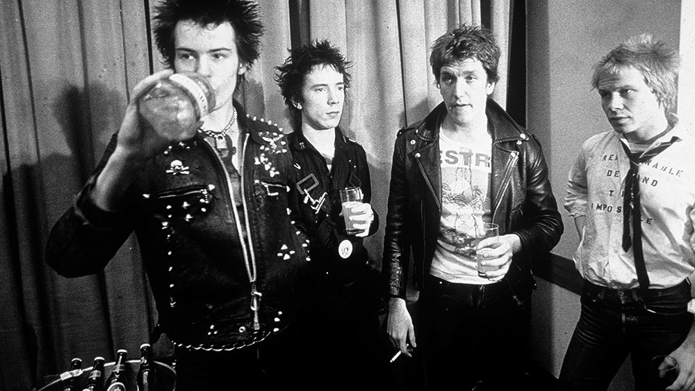 The Sex Pistols pose for a photo while drinking beer in the late 1970s