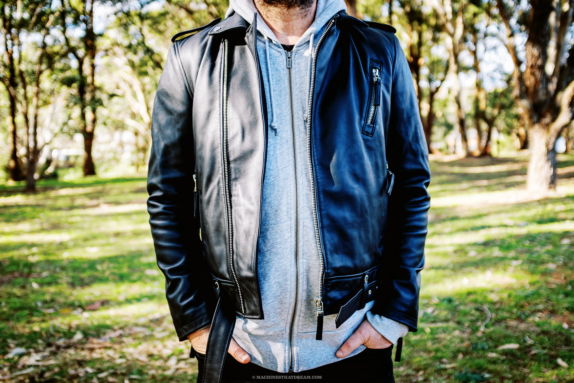 A strange man in a park wearing the Boda Skin's 'Voyager' leather motorcycle jacket