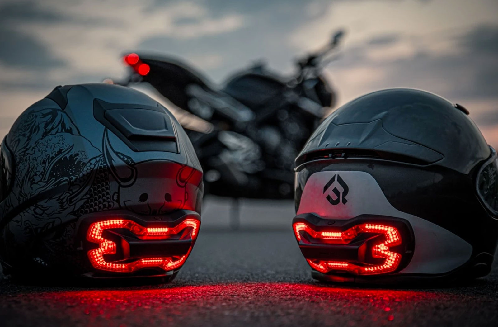 Two modern helmets fitted with Brake Free helmet brake lights