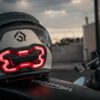 Motorcycle helmet with light on back sitting on Triumph bike