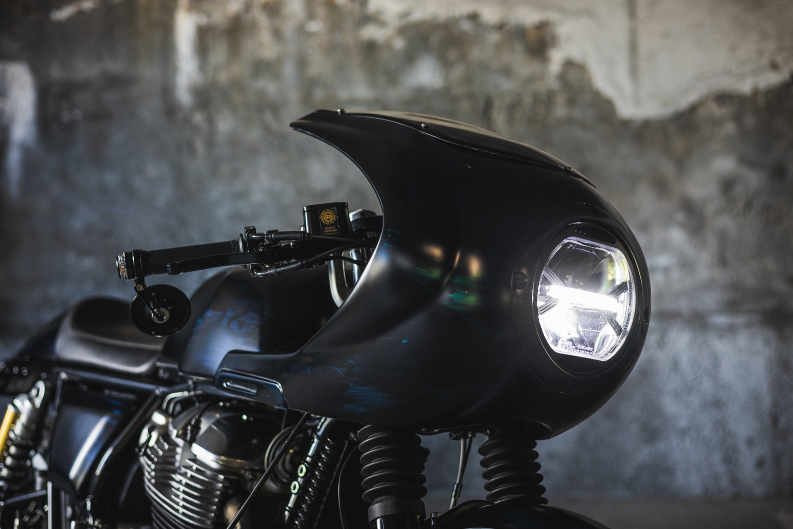 Close-up showing an Autologue Design fairing and a KOSO LED headlight for a Royal Enfield motorcycle