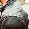 Left shoulder of man wearing ol Bobber Leather Jacket by Black Pup Moto
