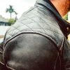 Right shoulder of man wearing ol Bobber Leather Jacket by Black Pup Moto