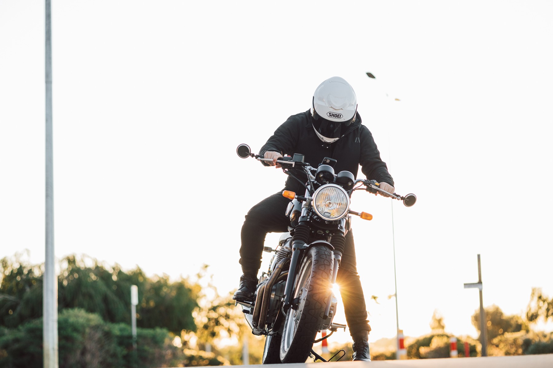 Biker on a motorcycle wearing the Akin Moto Hurricane hoodie