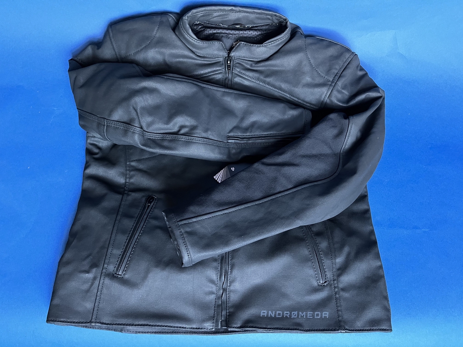 Front of Neowise Jacket by Andromeda Moto on blue background