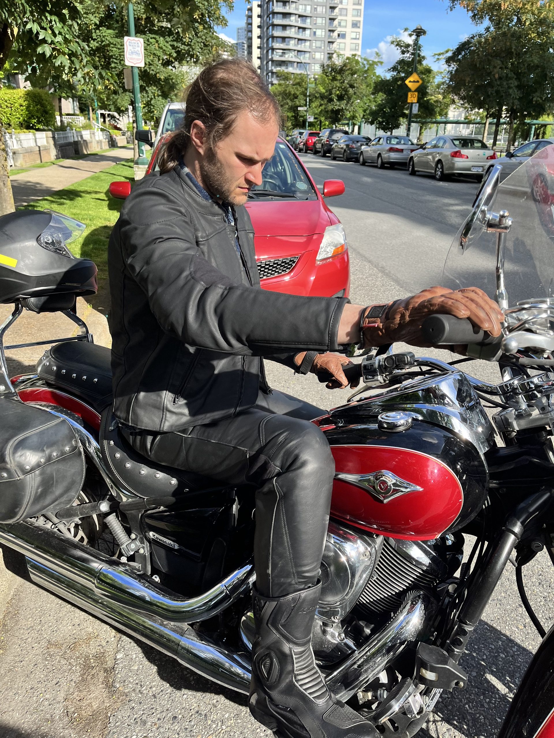Author sitting on motorcycle while wearing Neowise Jacket by Andromeda Moto