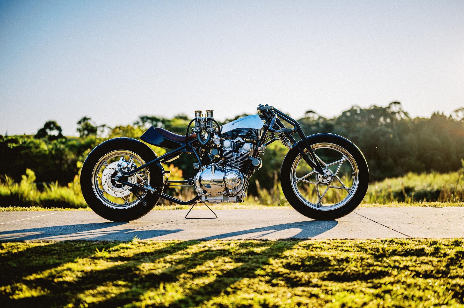 Machine 1867's custom motorcycle Suzuki GS650 Turbo drag bike on cement path outside