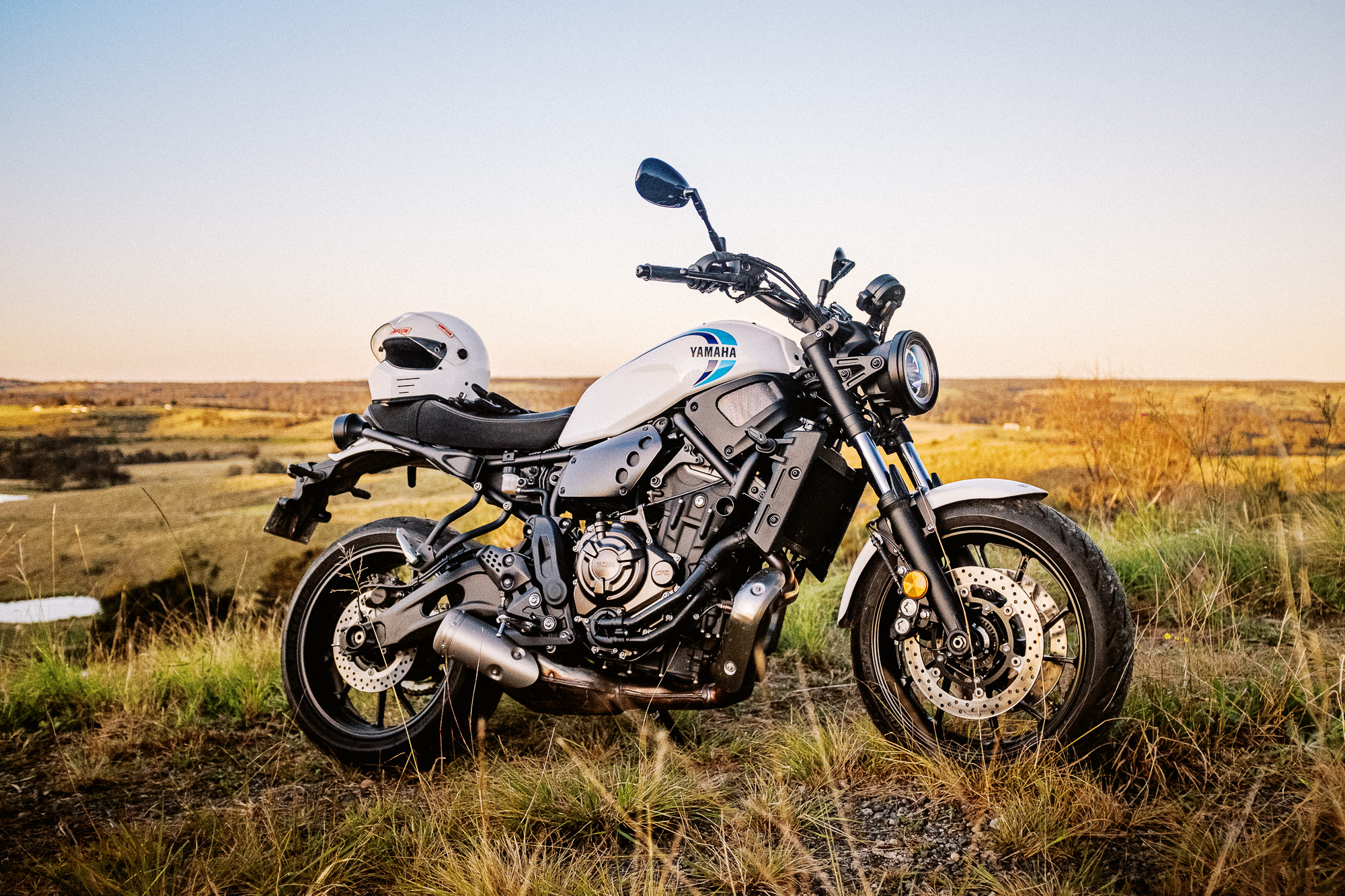 A 2020 Yamaha XSR700 motorcycle stands alson on a hill in Sydney's rural outer suburbs