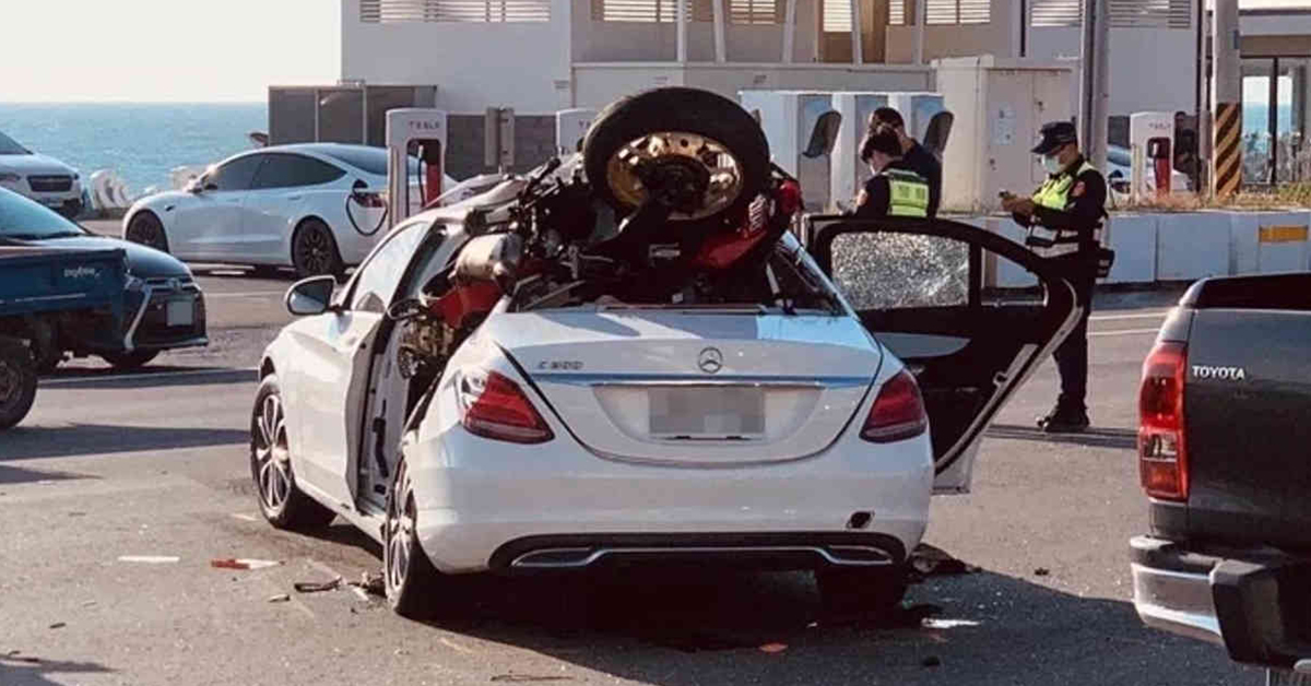 Motorcycle crashing into a white Mercedes Benz
