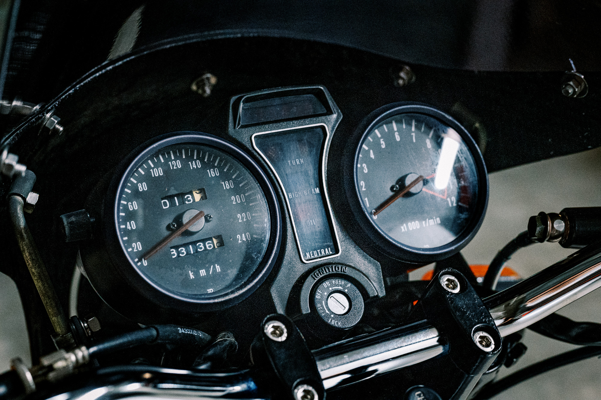 The instrument cluster of a 1981 Suzuki Katana Motorcycle in an underground carpark