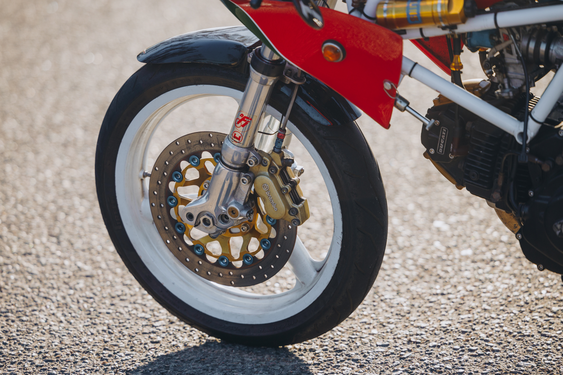 Detail photograph of a Ceriani NFI racing suspension setup for a Ducati motorcycle