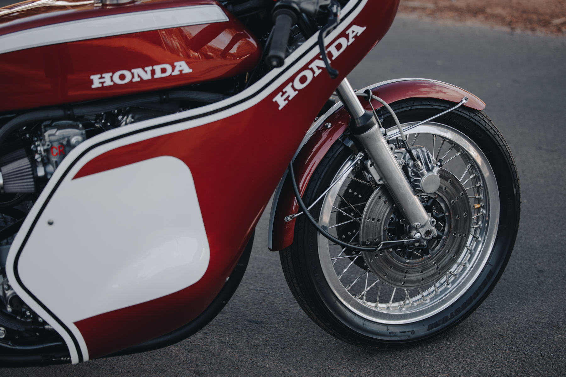 Detail photo of a red Honda CR750 motorcycle front wheel