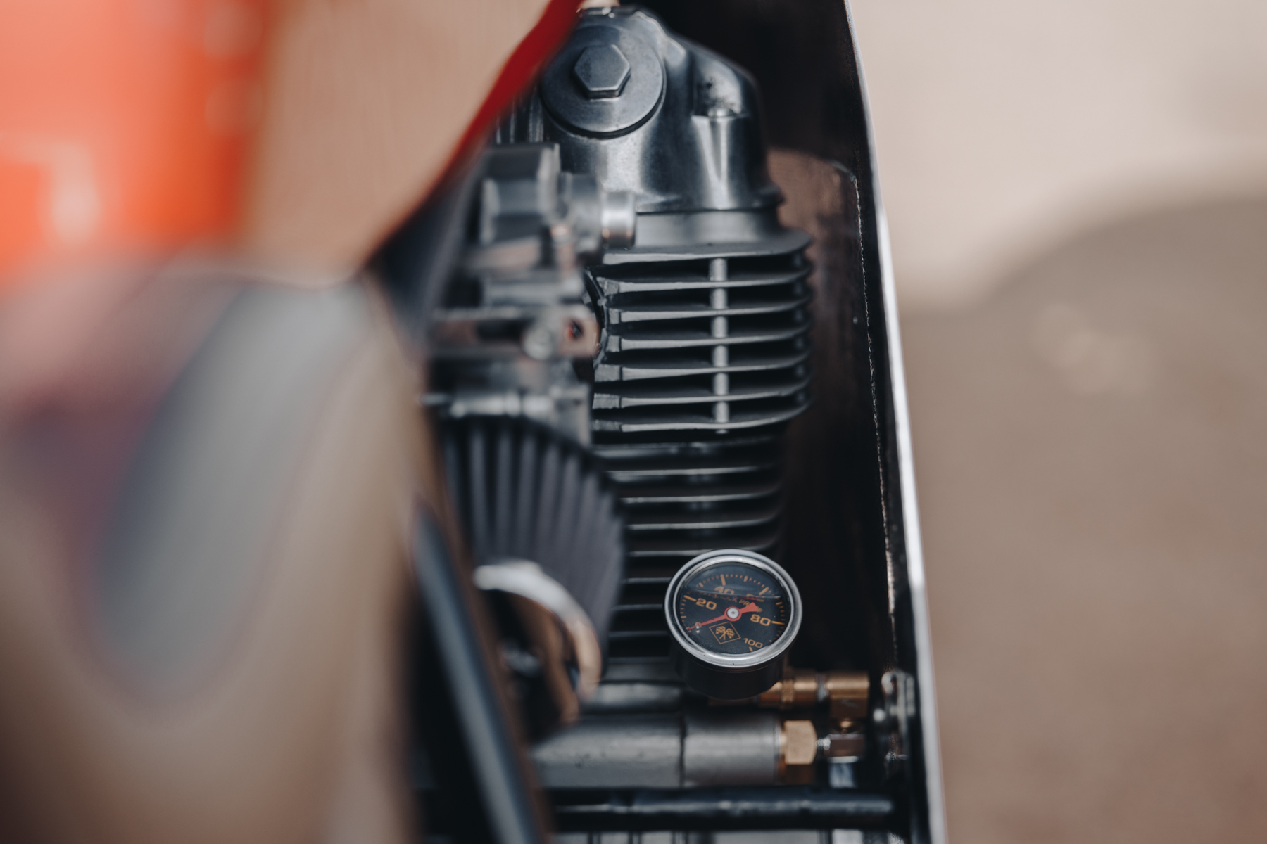 Detail photo of the right hand side of a Honda CB750 engine with oil temperature gauge